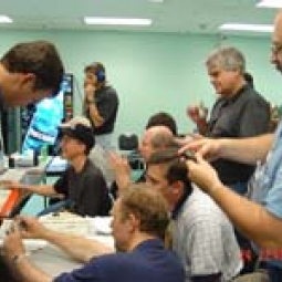 L-3 personnel in Waco control room applauding after successful proof-pressure test of the aircraft